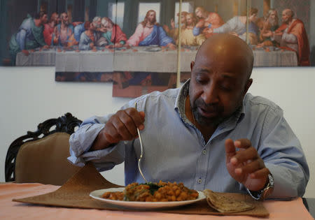 Berhanu Nega, an exiled Ethiopian Ginbot 7 rebel leader eats lunch in his apartment after a Reuters interview in Addis Ababa, Ethiopia October 19, 2018. Picture taken October 19, 2018. REUTERS/Tiksa Negeri