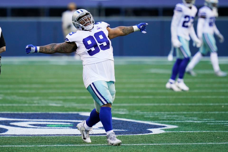 Dallas Cowboys defensive tackle Antwaun Woods (99) celebrates after he sacked Seattle Seahawks quarterback Russell Wilson during the second half of an NFL football game, Sunday, Sept. 27, 2020, in Seattle. (AP Photo/Elaine Thompson)