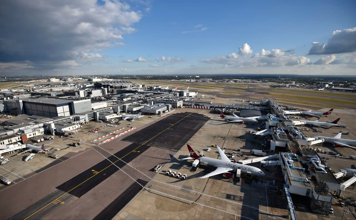 The man died while helping to unload baggage containers from a plane at Heathrow Airport (PA)