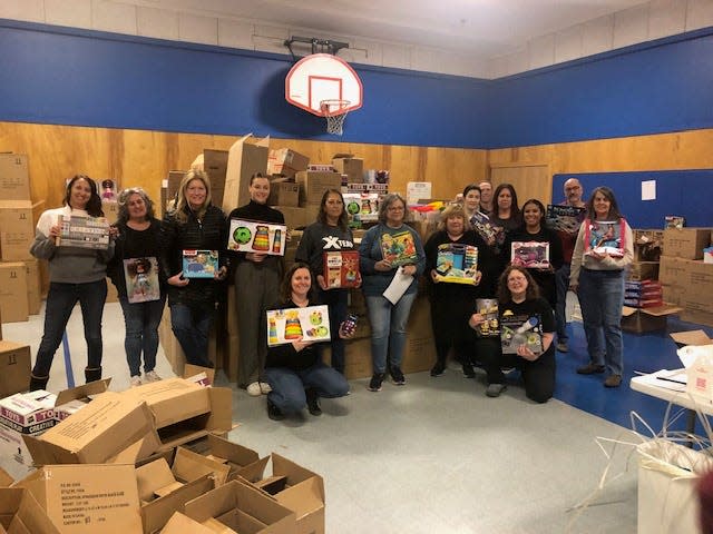 Volunteers sort boxes of toys that were purchased by the T&G Santa Fund to be distributed to needy children, last year at the Salvation Army in Worcester.