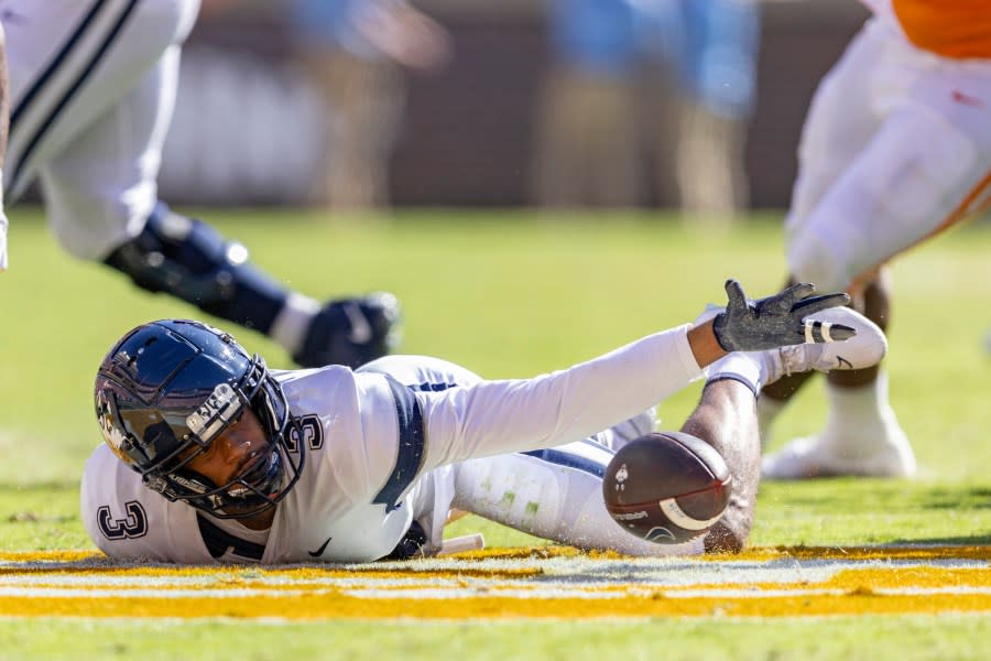 UConn wide receiver Geordon Porter (3) reaches for the ball as he fumbles it during the first half of an NCAA college football game against Tennessee, Saturday, Nov. 4, 2023, in Knoxville, Tenn. (AP Photo/Wade Payne)