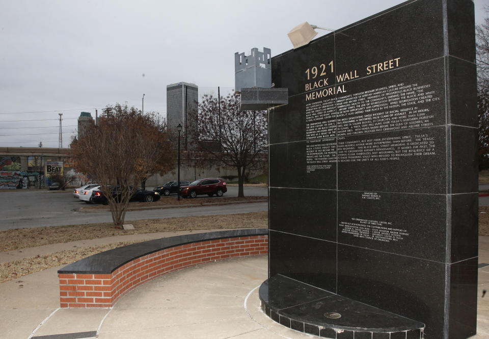 FILE - In this Dec. 15, 2016 file photo, a memorial to Tulsa's Black Wall Street sits outside the Greenwood Cultural Center on the outskirts of downtown Tulsa, Okla. A once-prosperous section of Tulsa that became the site of one of the worst race riots in American history is attempting to remake itself again after decades of neglect. G.T. Bynum mayor of Tulsa said on Tuesday, Oct. 2, 2018, he plans to re-examine whether mass graves hold remains of those killed in one of the nation's worst race massacres nearly 100 years ago. (AP Photo/Sue Ogrocki, File)