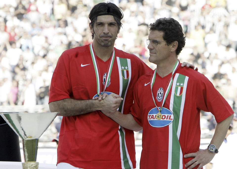 FILE - Juventus goalkeeper Gianluigi Buffon, left, and coach Fabio Capello stand next to the trophy after their team clinched the Serie A soccer title, at the San Nicola stadium in Bari, Italy, on May 14, 2006. At age 45 and after a career that included a World Cup title with Italy, a long list of trophies with Juventus and many years when he was considered among the best goalkeepers in soccer, Gianluigi Buffon announced his retirement on Wednesday, Aug. 2, 2023. (AP Photo/Antonio Calanni)