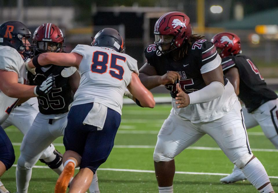 Peoria High's JaQuarius Green (75) and Jamere Fuller (55) try to hold back the Rochester defensive line in the first half of their opening night football game Friday, Aug. 25, 2023 at Peoria Stadium.