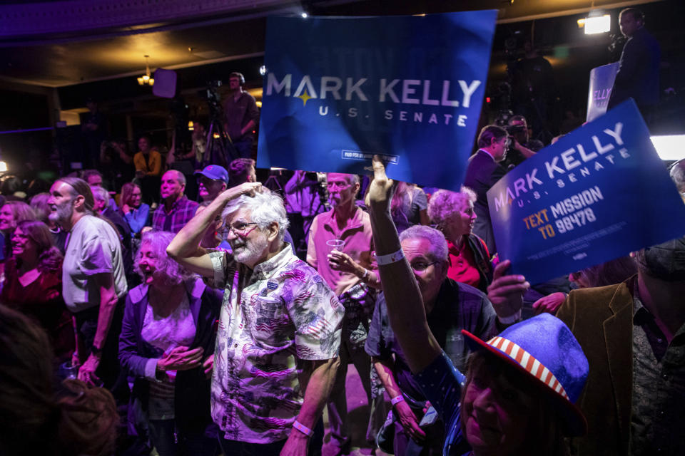 Supporters of Sen. Mark Kelly, D-Ariz., react as results come in during an election night event in Tucson, Ariz., Tuesday, Nov. 8, 2022. (AP Photo/Alberto Mariani)