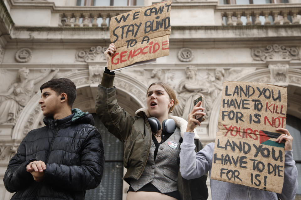 Demonstrators hold up flags and placards during a pro Palestinian demonstration in London, Saturday, Oct. 21, 2023. (AP Photo/David Cliff)