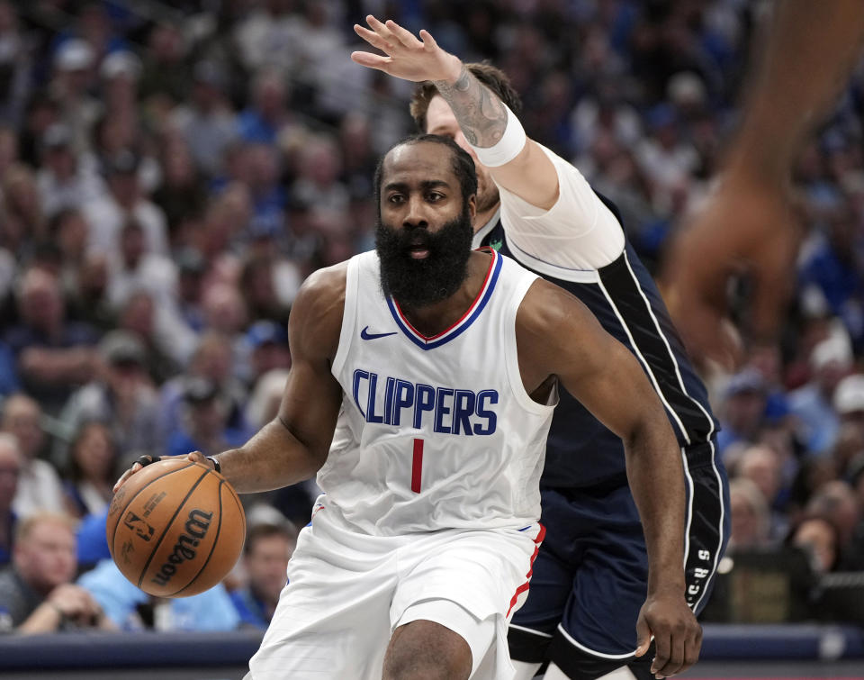 FILE - Los Angeles Clippers guard James Harden (1) drives past Dallas Mavericks guard Luka Doncic during Game 4 of an NBA basketball first-round playoff series April 28, 2024, in Dallas. As NBA free agency opened Sunday, June 30, 2024, Harden agreed to stay with the Clippers on a two-year contract worth up to $70 million, a person with knowledge of that agreement told The Associated Press. (AP Photo/Jeffrey McWhorter, File)