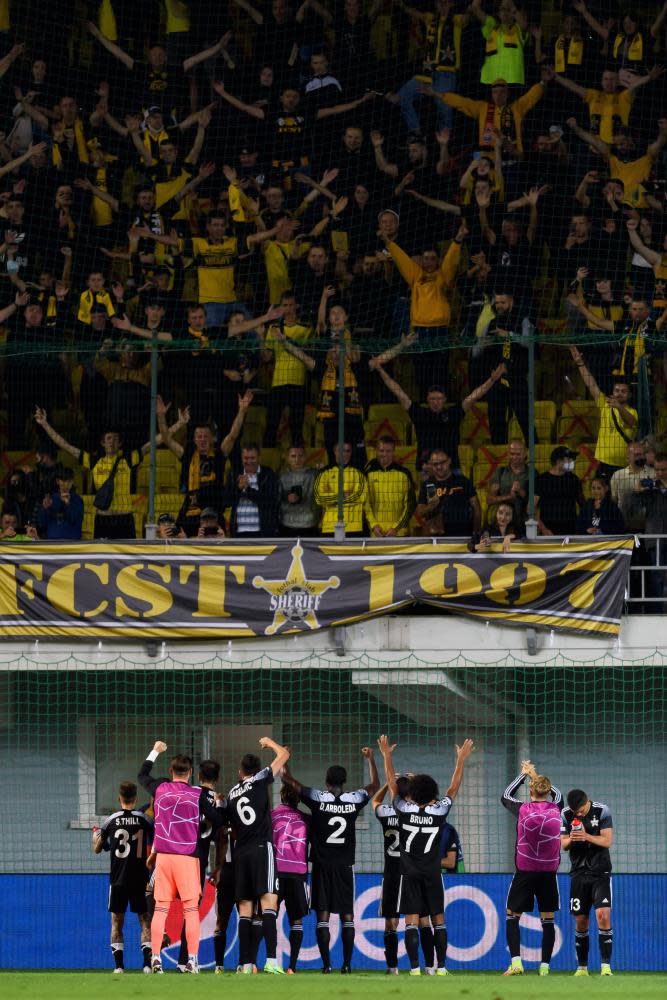 Sheriff Tiraspol players celebrate with the fans after beating Shakhtar Donetsk