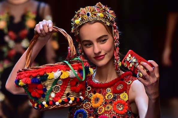 <p>Italians do it better and that really is the case when it comes to Dolce & Gabbana. The duo’s Spring 2016 collection was inspired by an Sicilian vacation, I mean, have you seen the designers’ vacation snaps on Instagram?! Models came down the runway taking selfies of themselves and the image was projected up on a screen. The lady carries a woven bag covered in multi colored pompoms and of course, the most important item, her phone which is accessorized with a jewel encrust Dolce & Gabbana phone case! <br></p><p>Photo: Getty</p>