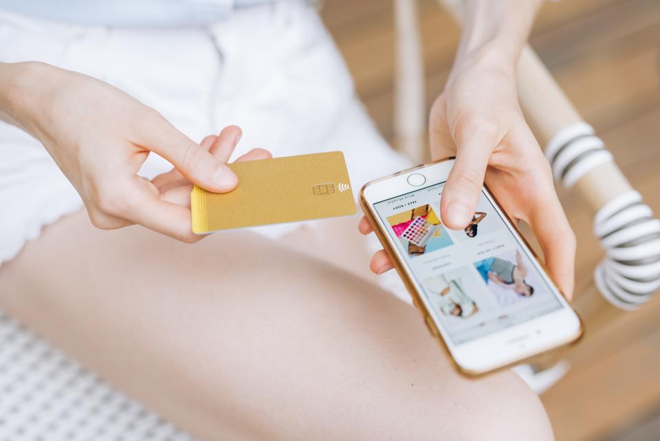 Woman shopping with credit card and phone 