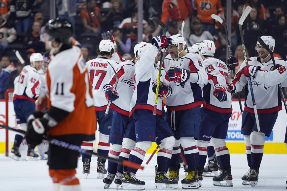 Washington Capitals' Alex Ovechkin (8) celebrates with teammates after the Capitals won an NHL hockey game against the Philadelphia Flyers, Tuesday, April 16, 2024, in Philadelphia. (AP Photo/Matt Slocum)