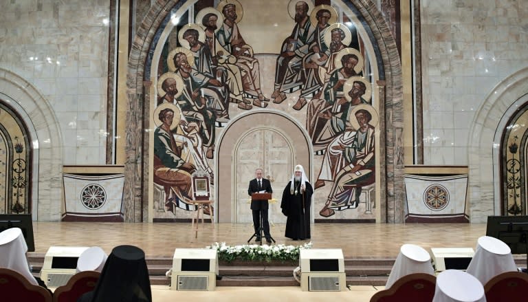 Russian President Vladimir Putin, accompanied by Patriarch Kirill, at a congress of Orthodox bishops at Moscow's Cathedral of Christ the Saviour