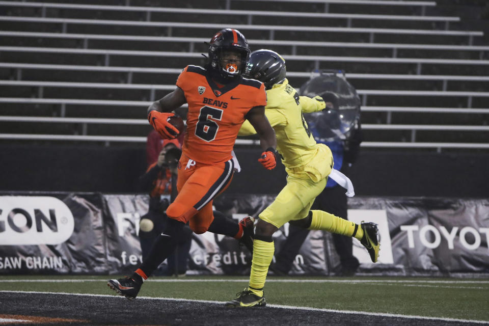 Oregon State running back Jermar Jefferson (6) runs past Oregon cornerback Mykael Wright (2) and into the end zone for a touchdown during the first half of an NCAA college football game in Corvallis, Ore., Friday, Nov. 27, 2020. (AP Photo/Amanda Loman)