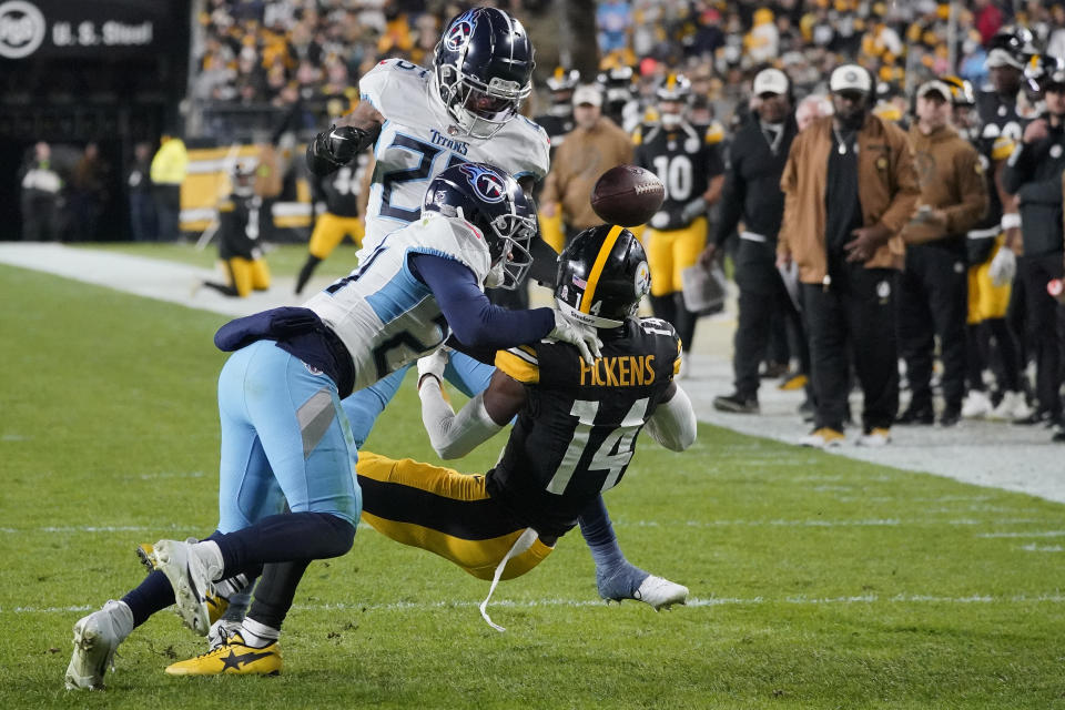 Pittsburgh Steelers wide receiver George Pickens (14) fumbles the ball out of bounds as he is tackled by Tennessee Titans defensive back Elijah Molden, left, and cornerback Kristian Fulton, behind, during the first half of an NFL football game Thursday, Nov. 2, 2023, in Pittsburgh. (AP Photo/Gene J. Puskar)