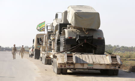 Iraqi military vehicles are being transported into Jurf al-Sakhar, as part of reinforcements after Iraqi troops seized the town October 25, 2014. REUTERS/Stringer