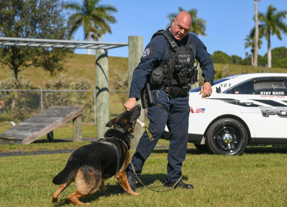 Port St. Lucie Police K9 Officer Mitch Miller plays with his dog Beck at the Port St. Lucie Police obstacle course along South Macedo Boulevard on Tuesday, Jan. 18, 2022, in Port St. Lucie. after almost four years together, Miller's K9 Beck will officially retire on Wednesday and become a part of Miller's family.