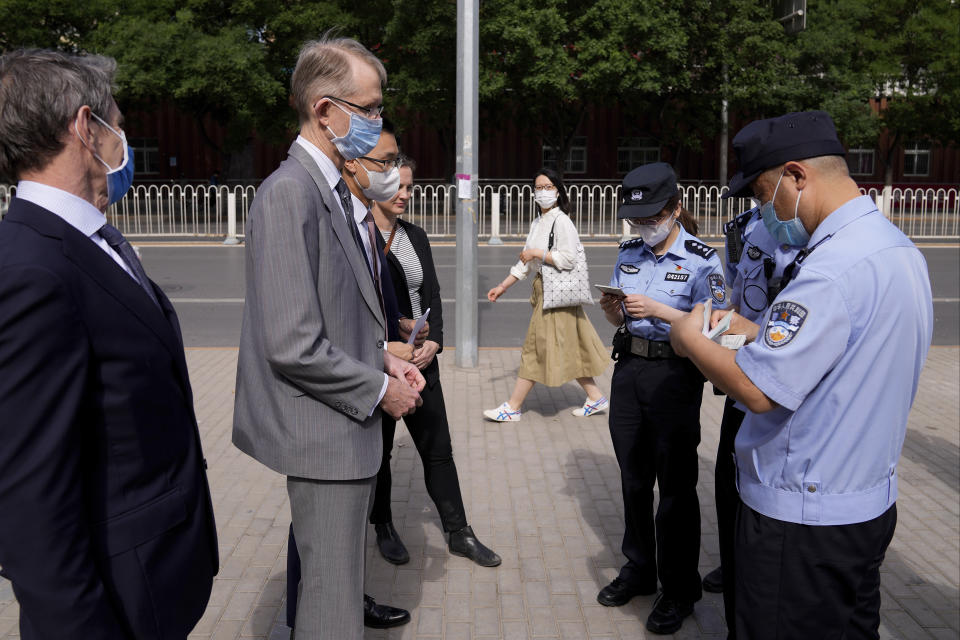 Australian ambassador to China Graham Fletcher, second left, is checked by policemen outside the No. 2 Intermediate People's Court as he arrives to attend the espionage charges case for Yang Hengjun, in Beijing, Thursday, May 27, 2021. Fletcher said it was “regrettable” that the embassy was denied access Thursday as a trial was due to start for Yang, a Chinese Australian man charged with espionage. (AP Photo/Andy Wong)