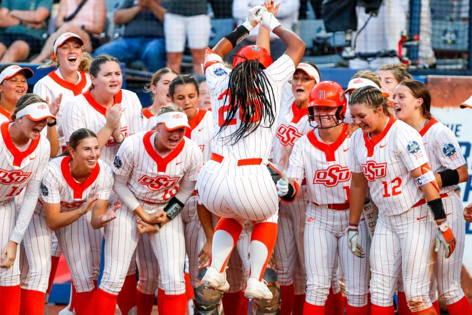 Oklahoma State infielder Morgyn Wynne (26) hits a home run during a softball game between Oklahoma State (OSU) and Tennessee at the Women's College World Series at USA Softball Hall of Fame Stadium in Oklahoma City on Sunday, June 4, 2023.