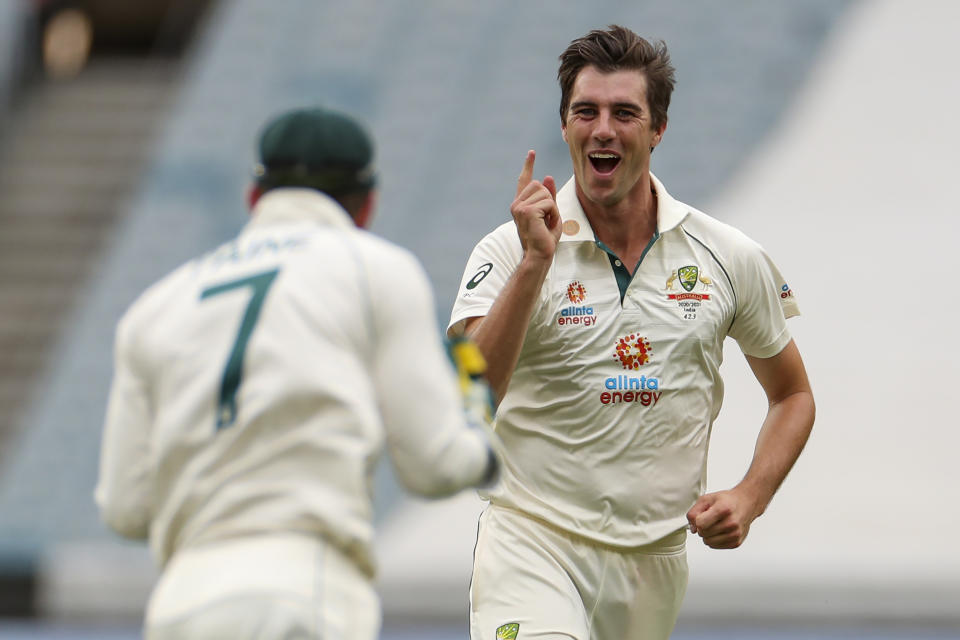 FILE - Australia's Pat Cummins, right, celebrates with teammate Tim Paine after taking the wicket of India's Cheteshwar Pujara during play on day two of the second cricket test between India and Australia at the Melbourne Cricket Ground, Melbourne, Australia on Dec. 27, 2020. Cummins was named as the new Australian team captain, Friday, Nov. 26, 2021 after the resignation of former captain Tim Paine, Friday, Nov. 19. (AP Photo/Asanka Brendon Ratnayake, File)