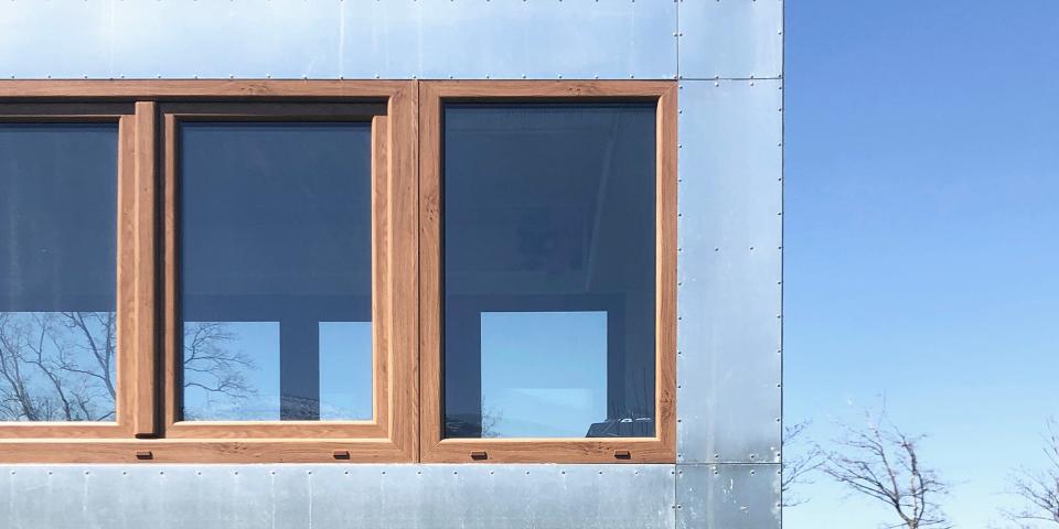 close up of the windows on a Good Spot mobile hotel while it's on a field