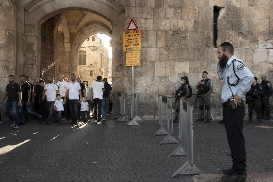 Israeli police stand guard at near the Lion's Gate as Palestinian protesters march into the Al Aqsa Mosque compound in the Old City of Jerusalem, Friday, Sept. 10, 2021. Amid increased Israeli-Palestinian tension over a recent prison break, Israeli police said an officer was lightly injured by a firearm in an attempt to thwart a suspected stabbing attack in the area. The Police, which arrested the suspect, did not immediately say how the officer was injured. (AP Photo/Maya Alleruzzo)