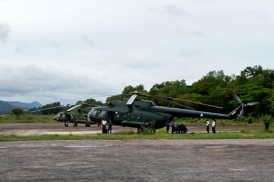 <p>Myanmar Air Force helicopters are pictured on standby to conduct rescue missions at Dawei Airport on June 8, 2017, the day after a military plane disappeared off the coast of Launglon, in southern Myanmar. (Photo: Ye Aung Thu/AFP/Getty Images) </p>