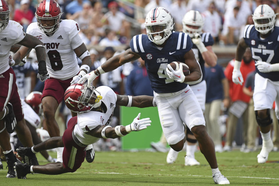FILE - Mississippi running back Quinshon Judkins (4) runs the ball past Troy safety Craig Slocum Jr. (4) during the first half an NCAA college football game in Oxford, Miss., Saturday, Sept. 3, 2022. Judkins was selected top first-year freshman in the Associated Press SEC Midseason Awards, Wednesday, Oct. 12, 2022. (AP Photo/Thomas Graning)