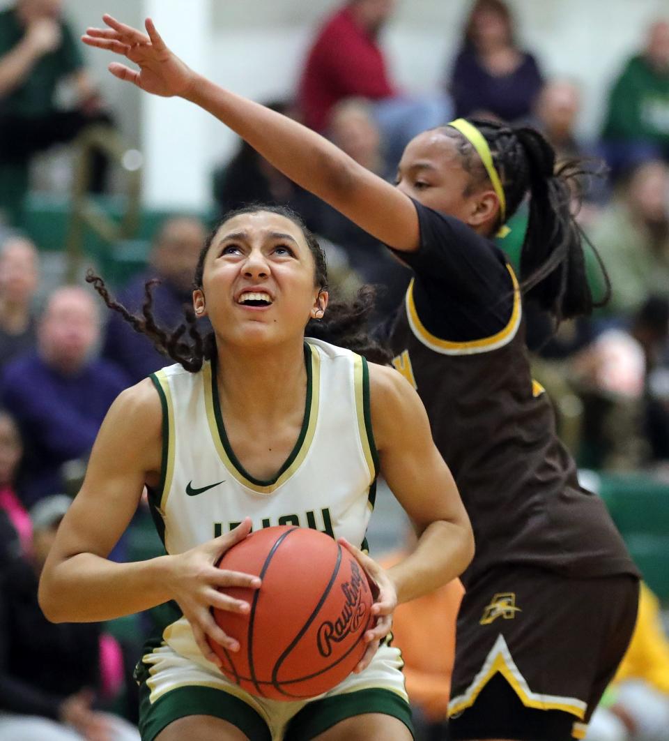 STVM guard Melania Cornute, left, looks to the basket for two ahead of a Brush defender during the first half of a high school basketball game, Wednesday, Jan. 31, 2024, in Akron, Ohio.