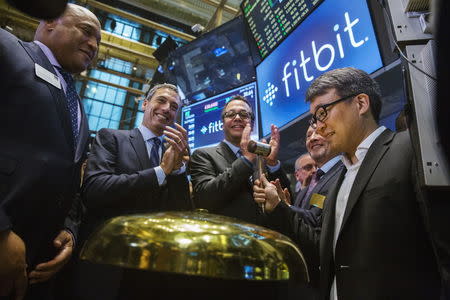 Fitbit Chief Executive James Park (R) rings a ceremonial bell marking the company's IPO on the floor of the New York Stock Exchange June 18, 2015. REUTERS/Lucas Jackson