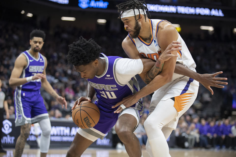 Sacramento Kings center Damian Jones (30) and Phoenix Suns center JaVale McGee (00) battle for position on the Kings offensive end in the first quarter of an NBA basketball game in Sacramento, Calif., Sunday, March 20, 2022. (AP Photo/José Luis Villegas)