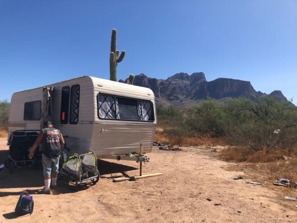 Steven Lee Thomas prepares to leave an abandoned trailer he stayed in the night before on Oct. 3, 2023. Thomas is one of dozens of people living in the desert land owned by the Bureau of Land Management.