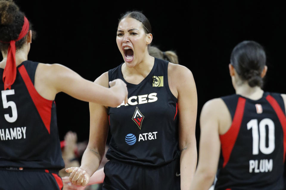 FILE - In this Sept. 24, 2019, file photo, Las Vegas Aces' Liz Cambage, center, celebrates after a play against the Washington Mystics during the second half of Game 4 of a WNBA playoff basketball series in Las Vegas. WNBA All-Star center Liz Cambage is set to return to the Australian women’s basketball league after signing with the Southside Flyers. (AP Photo/John Locher, File)