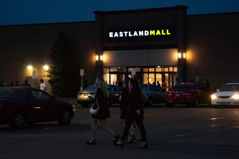 Two women walk past an entrance to Eastland Mall Saturday, May 13, 2023, just hours after multiple law enforcement agencies descended on the mall to investigate a large fight and potential "active shooter" incident.