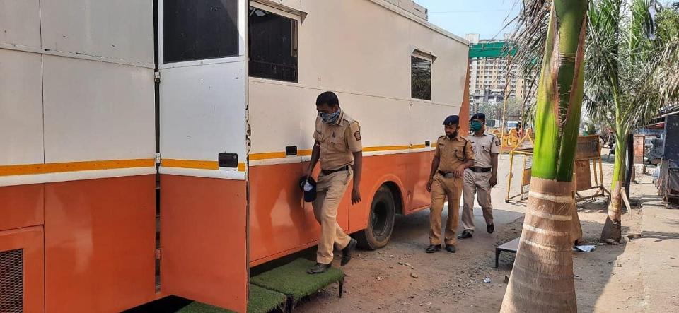 <div class="paragraphs"><p>Policemen outside Ketan Rawal's van</p></div>