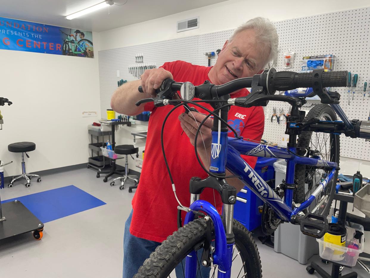 Bicycle repair mechanic Eric Havenhill volunteers at Charity Bicycles in Brighton Township on Tuesday, April 23.
