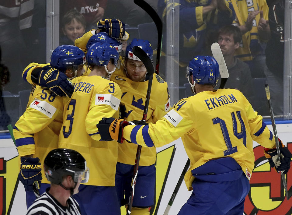 Sweden players celebrate after scoring during the Ice Hockey World Championships group B match between Sweden and Latvia at the Ondrej Nepela Arena in Bratislava, Slovakia, Monday, May 20, 2019. (AP Photo/Ronald Zak)