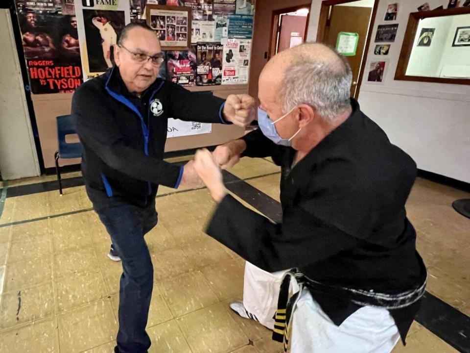 Jim Maloney (left) continues to train martial arts fighters after several decades. (Paul Palmeter/CBC - image credit)