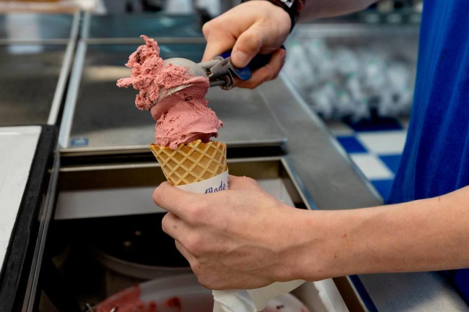 Jackson Monroe scoops black raspberry chunk ice cream for a customer at Handel’s Homemade Ice Cream in Forest Acres.
