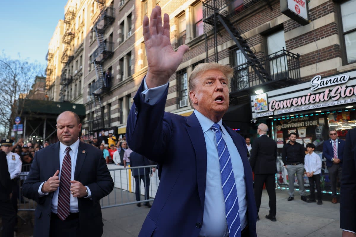 Former president Donald Trump, talks to members of the media while visiting a bodega, after leaving court for his hush money trial on Tuesday 16 April 2024 (AP)