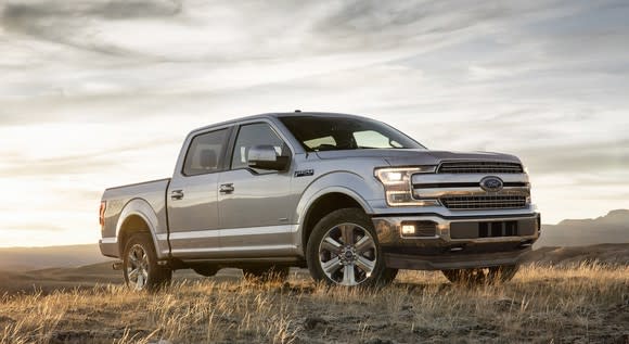 A silver Ford F-150 pickup in a field.