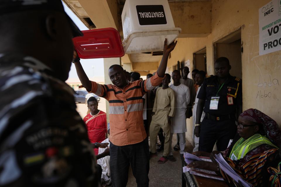 An electoral official holds up an empty ballot box at a polling station after the presidential and parliamentary elections in Yola, Nigeria, Saturday, Feb. 25, 2023. Voters in Africa's most populous nation are heading to the polls Saturday to choose a new president, following the second and final term of incumbent Muhammadu Buhari. (AP Photo/Sunday Alamba)