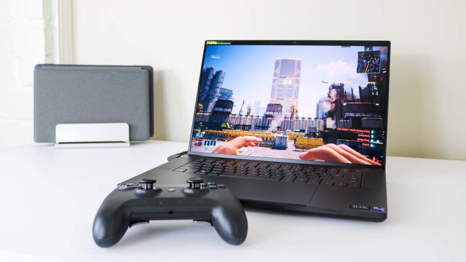 The Razer Blade 16 (2024) on a desk with a controller