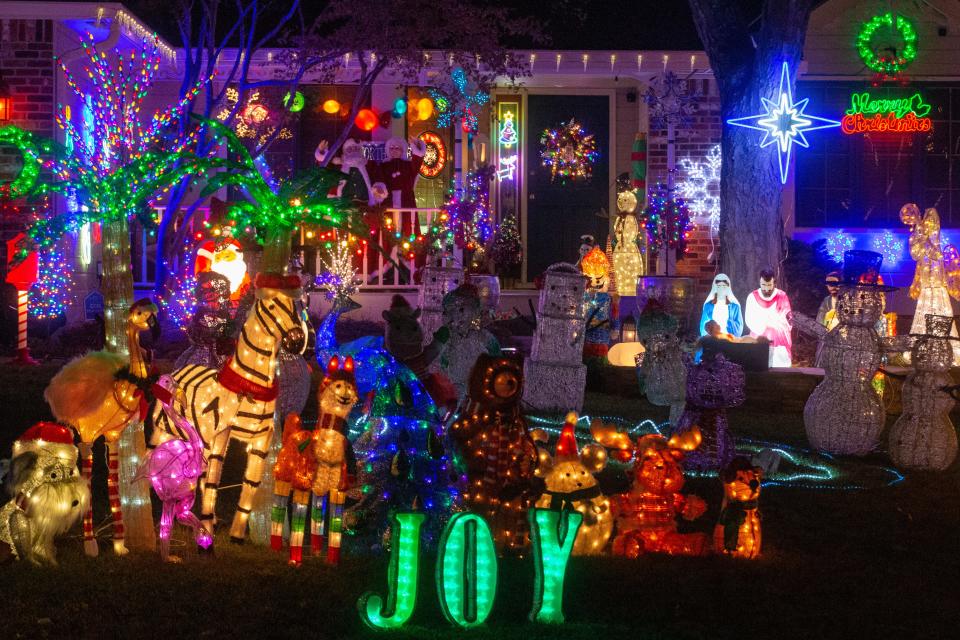 A collage of holiday, Christmas and North Pole inspired decorations fill up the yard at 3032 S.W. Staffordshire Road while music plays from outside speakers.