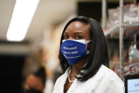 FILE - In this Feb. 11, 2021, file photo, Kizzmekia Corbett, an immunologist with the Vaccine Research Center at the National Institutes of Health (NIH) looks on as President Joe Biden visits the Viral Pathogenesis Laboratory at the NIH in Bethesda, Md. Corbett played a key role in developing the Moderna vaccine. (AP Photo/Evan Vucci, File)