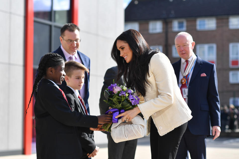 The Duchess of Sussex is greeted by pupils at the Robert Clack Upper School in Dagenham, Essex, during a surprise visit to celebrate International Women's Day.