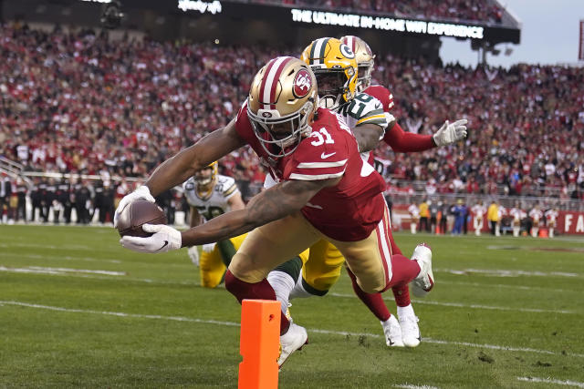 San Francisco 49ers running back Raheem Mostert stiff-arms Las