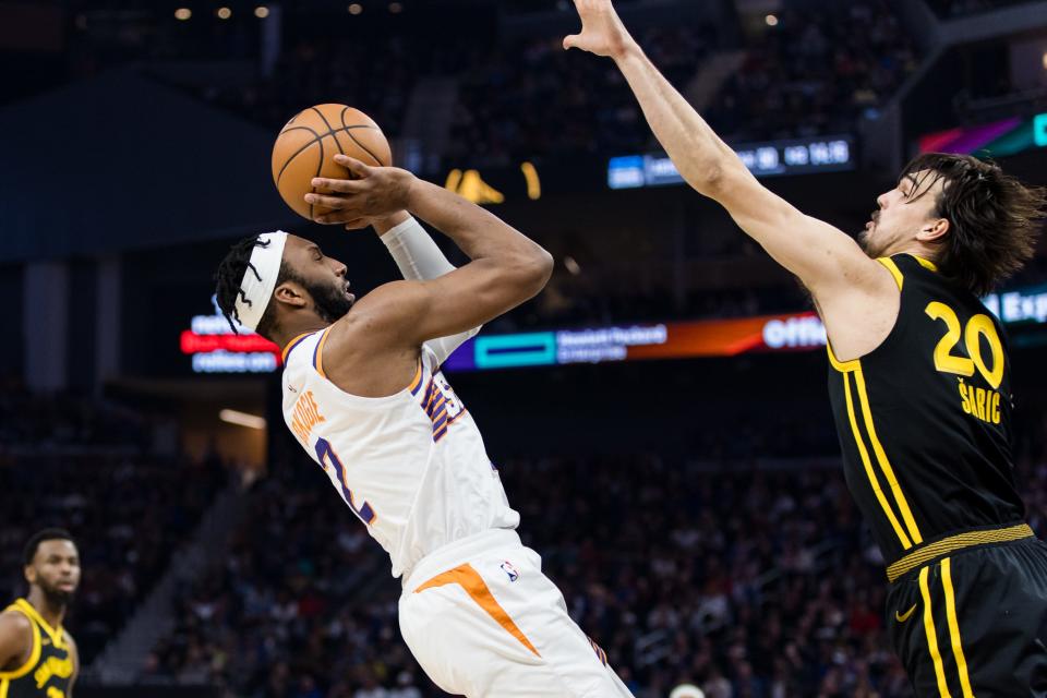 Golden State Warriors forward Dario Saric (20) defends against Phoenix Suns forward Josh Okogie (2) during the first half at Chase Center in San Francisco on Feb. 10, 2024.