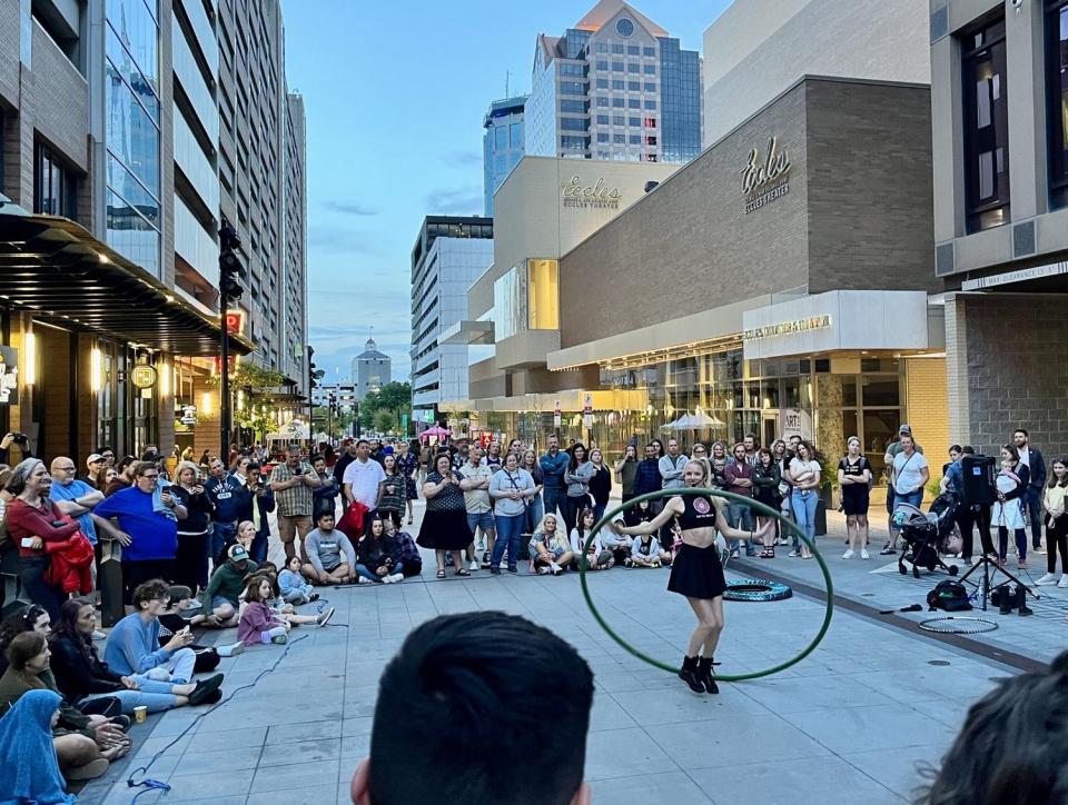 A crowd forms on Regent Street in downtown Salt Lake City to watch a street performer during the Salt Lake City Busker Fest on May 26. Downtown Salt Lake City has been more active over the past two years than before the COVID-19 pandemic, according to University of Toronto data.