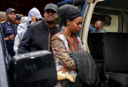 Diane Shima Rwigara, a leading critic of Rwanda's president, is escorted by her family members after she was arrested by police in Kigali, Rwanda, September 4, 2017. REUTERS/Jean Bizimana