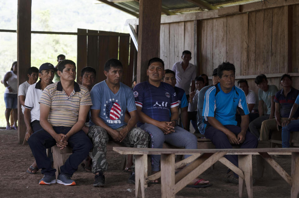 Residents of the Puerto Franco community attend a meeting, in Peru's Amazon, Monday, Oct. 3, 2022. Residents in Kichwa Indigenous villages in Peru say they fell into poverty after the government turned their ancestral forest into a national park, restricted hunting and sold forest carbon credits to oil companies. (AP Photo/Martin Mejia)